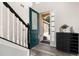 A view of the front door, a staircase with white railings and wood floors at 13247 Hatherton Cir, Orlando, FL 32832