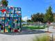 Outdoor gathering space featuring a colorful stained glass installation and picnic tables near the lake at 13247 Hatherton Cir, Orlando, FL 32832