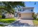 Home exterior with brick driveway, stone accents, and manicured lawn beneath a shady tree at 13247 Hatherton Cir, Orlando, FL 32832
