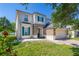 Charming two-story home features green shutters, a stone accent wall, and well-maintained landscaping at 13247 Hatherton Cir, Orlando, FL 32832