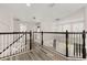 Spacious upstairs hallway with modern chandelier and sleek laminate flooring at 13247 Hatherton Cir, Orlando, FL 32832