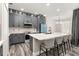Stylish kitchen featuring gray cabinetry, large island and stainless steel appliances at 13247 Hatherton Cir, Orlando, FL 32832