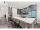 Bright kitchen featuring gray cabinetry, large island and stainless steel appliances at 13247 Hatherton Cir, Orlando, FL 32832