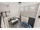 Open concept living area with modern lighting, gray plank flooring, and blue sofa at 13247 Hatherton Cir, Orlando, FL 32832