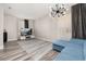 Contemporary living room featuring wood floors, a TV, and stylish lighting fixture at 13247 Hatherton Cir, Orlando, FL 32832