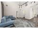 Inviting living room with high ceilings, modern finishes, and comfortable blue sofa at 13247 Hatherton Cir, Orlando, FL 32832
