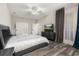 Spacious main bedroom with stylish furniture, a ceiling fan, and large windows with elegant curtains at 13247 Hatherton Cir, Orlando, FL 32832