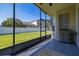 Screened in back patio features a grill and a view of the fenced in yard at 13247 Hatherton Cir, Orlando, FL 32832