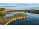 Scenic view of the golf course and pond featuring the reflection of nearby homes at 13247 Hatherton Cir, Orlando, FL 32832