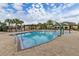 Resort-style pool with a splash pad, palm trees, and ample deck space for relaxation and recreation at 13247 Hatherton Cir, Orlando, FL 32832