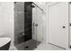 Contemporary shower with black and white marble tile and a glass enclosure at 13247 Hatherton Cir, Orlando, FL 32832