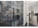 This shower features marble-like tiles, glass door and a rainfall shower head at 13247 Hatherton Cir, Orlando, FL 32832