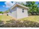 Side view of the home exterior showing yard and window views at 1411 N Powers Dr, Orlando, FL 32818