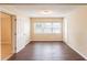 Spacious bedroom with laminate wood flooring and natural light from a large window at 1411 N Powers Dr, Orlando, FL 32818