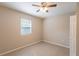 Bedroom with light tan tiled flooring, ceiling fan, window and a closet at 1411 N Powers Dr, Orlando, FL 32818