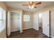 Bedroom with closet, wood floors, neutral colors, and access to ensuite bathroom at 1411 N Powers Dr, Orlando, FL 32818