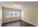 Neutral bedroom with vinyl wood flooring, large window, and a closet at 1411 N Powers Dr, Orlando, FL 32818