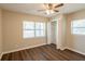 Cozy bedroom with dark wood floors, closet, and bright natural light at 1411 N Powers Dr, Orlando, FL 32818