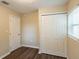 Bedroom featuring wood floors, double closet, and bright natural light at 1411 N Powers Dr, Orlando, FL 32818