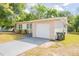 Home featuring an attached one-car garage and a well-maintained front yard at 1411 N Powers Dr, Orlando, FL 32818