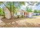 Exterior view of the home and yard highlighting the side view at 1411 N Powers Dr, Orlando, FL 32818