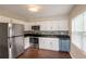 Updated kitchen featuring stainless steel appliances and bright white cabinets at 1411 N Powers Dr, Orlando, FL 32818