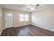 Bright room featuring a new white front door, laminate floors, and a large window at 1411 N Powers Dr, Orlando, FL 32818