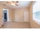 Bright living room features tile floors, ceiling fan, and door to the home's exterior at 1411 N Powers Dr, Orlando, FL 32818