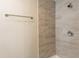 Detail of modern bathroom shower with neutral toned tile and updated hardware at 1411 N Powers Dr, Orlando, FL 32818