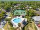 Aerial view of the community pool, tennis court and surrounding lush landscaping at 1450 Harbour Dr, Longwood, FL 32750