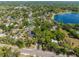 An aerial view of the community highlighting the lush landscaping and a nearby lake at 1450 Harbour Dr, Longwood, FL 32750