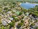 Aerial view of the neighborhood with mature trees, tennis courts, swimming pool and a lake at 1450 Harbour Dr, Longwood, FL 32750