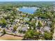 Aerial view of community showcasing lake, tennis courts, pool and lush surroundings at 1450 Harbour Dr, Longwood, FL 32750
