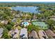 Aerial view of community showcasing the pool, tennis courts and lake at 1450 Harbour Dr, Longwood, FL 32750