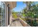 Charming balcony with metal railing offering views of lush greenery and blue skies at 1450 Harbour Dr, Longwood, FL 32750