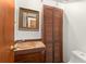 Charming bathroom with unique vanity, decorative mirror, and ample storage space at 1450 Harbour Dr, Longwood, FL 32750