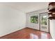 Bright bedroom with hardwood floors, a window with a view, and a door to the outside at 1450 Harbour Dr, Longwood, FL 32750