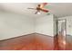 A spacious bedroom featuring hardwood floors, a ceiling fan, and ample natural light at 1450 Harbour Dr, Longwood, FL 32750