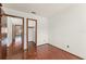 Bedroom featuring beautiful hardwood floors, closet and views into another room at 1450 Harbour Dr, Longwood, FL 32750