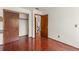 Bedroom featuring closet with dark wood doors and hardwood floors and light colored walls at 1450 Harbour Dr, Longwood, FL 32750