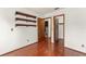 Bedroom with hardwood floors, white walls, floating shelves and two entryways at 1450 Harbour Dr, Longwood, FL 32750