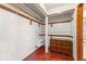 A closet showcasing a dresser and shelving for storage, with hardwood floors at 1450 Harbour Dr, Longwood, FL 32750