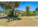Side view of a two-story home showcasing mature landscaping and lush greenery at 1450 Harbour Dr, Longwood, FL 32750