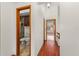 Hallway displaying hardwood floors and a bathroom view with a toilet and bidet at 1450 Harbour Dr, Longwood, FL 32750