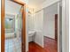 Hallway showing the bathroom and the entrance to a bedroom with hardwood floors at 1450 Harbour Dr, Longwood, FL 32750