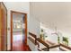 Hallway and stairs leading to the living room, showcasing natural lighting and hardwood floors at 1450 Harbour Dr, Longwood, FL 32750