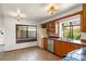 Well-lit kitchen featuring wood cabinets, stainless steel appliances, and tile countertops at 1450 Harbour Dr, Longwood, FL 32750