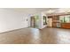 Bright room featuring sliding glass door, window with storage, kitchen and tile floor at 1450 Harbour Dr, Longwood, FL 32750