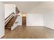 Bright, open living room featuring tile flooring, a wooden staircase, and a neutral color palette at 1450 Harbour Dr, Longwood, FL 32750