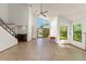 Bright living room features high ceilings, tile floors, and large windows overlooking the landscaped yard at 1450 Harbour Dr, Longwood, FL 32750